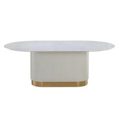 an oval dining table with a white marble top and gold trim around the base,