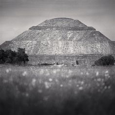 a large pyramid in the middle of a field