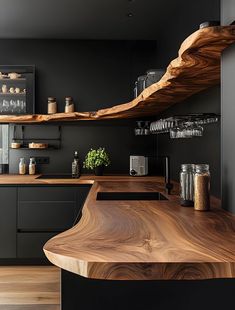 a wooden counter top in a kitchen with black walls