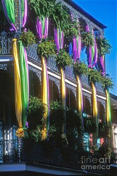 there are many different colored umbrellas hanging on the building