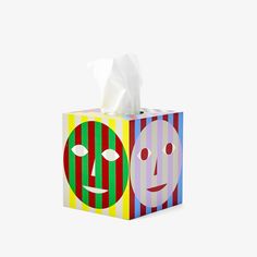 a tissue box with two faces on it