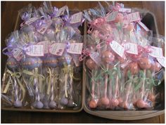 two trays filled with cake pops and candies