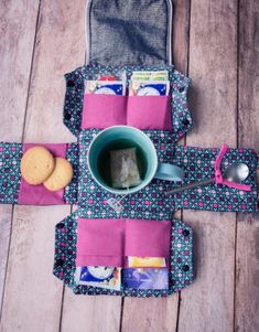 a tea cup and cookie on a table