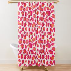 a shower curtain with an orange and pink leopard print on the outside, along with a white bath tub