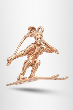 If you love skiing and vintage jewelry, this 14K yellow gold skiing figure charm is the perfect piece for you. Its timeless design captures the joy of winter sports. A beautiful addition to any charm bracelet or necklace. #vintagejewelry #skiingcharm #goldjewelry