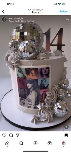 a birthday cake decorated with disco balls and ribbons on top of a white platter