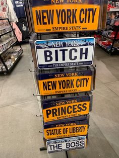 several new york city license plates are on display in a store, with the price tag below them