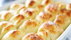 a pan filled with bread rolls on top of a table