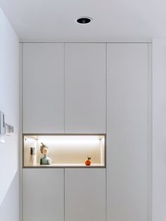 a room with white walls and cupboards in it