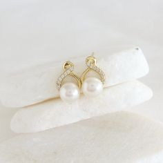 This feminine pearl stud earring adds just the right amount of sparkle to your collection, Crafted in Sterling Silver, and freshwater pearls, they are a sweet choice for a dear friend and the perfect gift to bridesmaids. P R O D U C T * D E T A I L S    - High Quality Solid 925 Sterling Silver - Finish -Silver / 14K Gold / 14K Rose Gold - Sparkling baguette Cut Cubic Zirconia Halo - Freshwater Pearls 8 mm - Measures 15 mm - Center posts with butterfly backs (for pierced ears)  - Lightweight, Hypoallergenic, lead & nickel free. **Our freshwater pearls are lovingly chosen just for you. Because they're natural, each one is unique, with its own special size, shape, and color. No two pearls are exactly alike, making your piece one-of-a-kind! ♥ Check Our Pearl Earrings Collection: https://etsy.m Fine Jewelry Pearl Bridal Earrings For Anniversary, Elegant Infinity Earrings For Formal Occasions, Fine Pearl Bridal Earrings For Anniversary, Pearl White Bridal Earrings For Anniversary, Elegant Infinity Earrings For Wedding, Graceful Pearl Earrings For Anniversary, Yellow Gold Pear-shaped Pearl Earrings For Anniversary, Elegant Infinity Earrings For Anniversary, Elegant Infinity White Gold Earrings