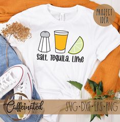 a t - shirt that says salt, tequila and lime on it next to a pair of jeans