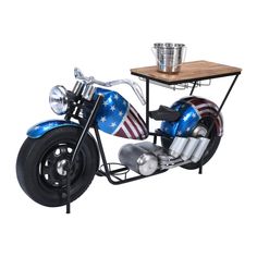 a motorcycle with an american flag painted on the side and a wooden table attached to it