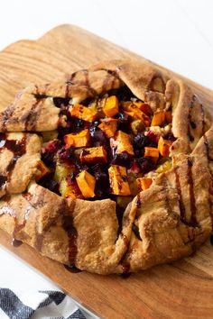 a pie sitting on top of a wooden cutting board