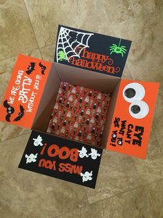 three halloween cards in a box with the words happy halloween on them and two rolls of toilet paper