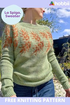 a woman wearing a green sweater with orange flowers on it and the words la spiga sweater