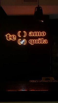 the neon sign says te i amo quilla in spanish and it is lit up at night