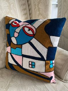 a decorative pillow is sitting on a chair