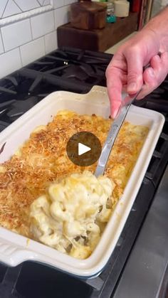 a person cutting food into a casserole dish