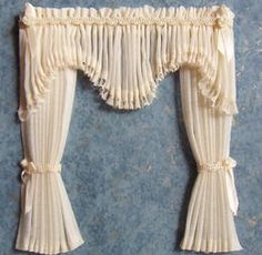 the curtain is made out of pleated fabric and has ruffles on it