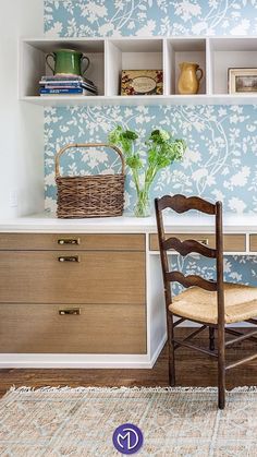 A nicely decored study room or a home office area with a stylish khaki colored jute rug, flowers on desk and a blue wall. Black Couches, Spring Refresh