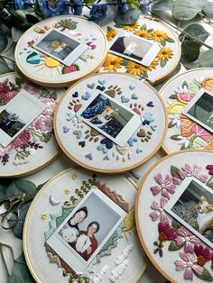 several embroidered pictures are arranged on the table