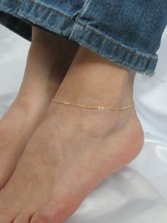 Gold ankle bracelet, delicate gold anklet, Gold fill ankle bracelet, Minimalist ankle bracelet This listing is for an elegant single chain gold fill ankle bracelet. The anklet closes with a gold fill clasp and has a small extender chain attached.  Length of anklet at 24cm (9.5 inches) - Custom length available upon request.  The anklet comes boxed ready for gifting. Please contact me if you have any questions. Thanks for looking. Also available with rose gold fill chain https://www.etsy.com/uk/l Gold Anklets With Delicate Chain As Gift, Gold Anklets With Delicate Chain For Gift, Delicate Gold Chain Anklets As Gift, Gold Delicate Anklet For Gift, Delicate Gold Anklets As Gift, Dainty Gold Anklet With Delicate Chain, Delicate Gold Anklet For Gift, Adjustable Gold Chain Dainty Anklet, Adjustable Dainty Gold Chain Anklet