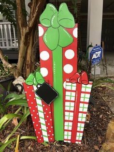 a wooden sign with bows and presents on it