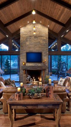 a living room filled with furniture and a flat screen tv mounted on the wall above a fire place