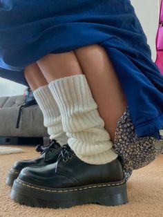 a person wearing black shoes and socks with white socks