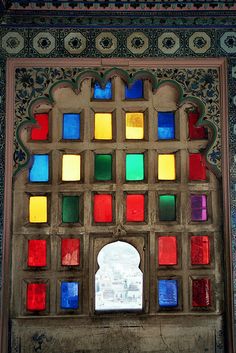 an ornate window with colorful glass in it