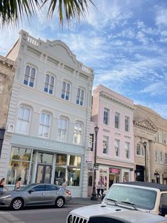 cars are parked on the street in front of buildings