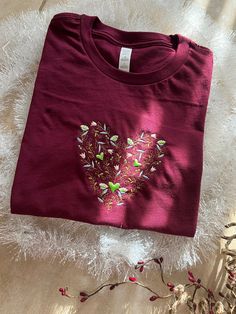 *These embroidered Floral Heart shirts are made of 100% cotton, light weight and delicate. These embroidered shirts are perfect for gifting or for yourself , especially perfect for Valentine. *The model is 5 ft 1 tall, 105 lbs weight wearing size S. * Available in Maroon color. The color in the pictures may slightly different from the actual products due to the light when taking the pics. *Since each shirt is embroidered separately, there may be small differences in the embroidery. Maroon Top, Embroidered Shirts, Floral Heart, Maroon Red, Heart Shirt, Embroidered Tshirt, Maroon Color, Embroidered Shirt, Houston Tx