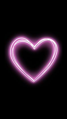 a neon heart on a black background