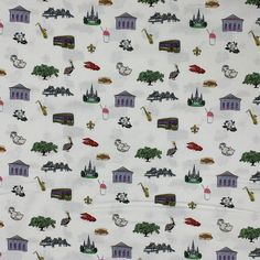 a white fabric with buildings and trees on it