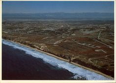 an aerial view of the ocean and land