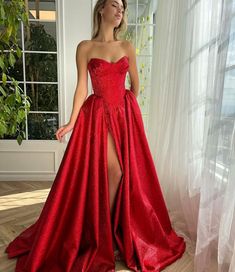 Ruby Luminescence Pleated Gown | Teuta Matoshi Floor-length Gown For Debutante Ball Gala, Glamorous Strapless Gown For Debutante Ball, Red Gown With Corset Back For Formal Occasions, Glamorous Formal Ball Gown With Corset Back, Floor-length Corset Dress With Boned Bodice For Prom, Glamorous Strapless Prom Ball Gown, Red Corset Dress For Gala During Prom Season, Glamorous Evening Dress With Corset Back For Debutante Ball, Taffeta Gown With Sweep Train And Fitted Bodice