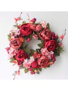 a floral wreath with pink and red flowers