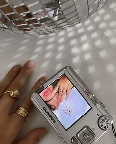 a hand holding a cell phone with a picture on the screen