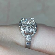 a woman's hand with a diamond ring on it