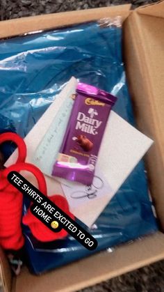 a box with scissors, candy and other items in it