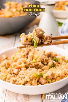 pork fried rice in a white bowl with chopsticks sticking out of the top