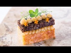 a piece of food that is sitting on top of a marble surface with flowers in the middle