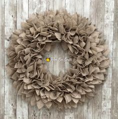 a wreath is hanging on the side of a wooden wall