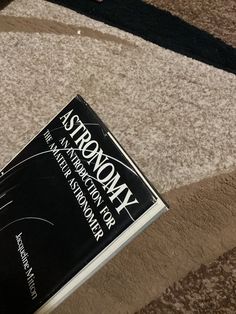 a book sitting on top of a carpet covered floor