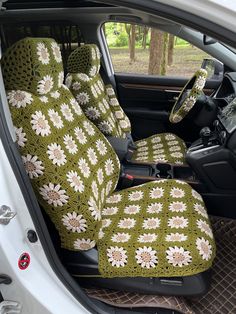 the interior of a car is decorated with green and white crocheted flowers on it