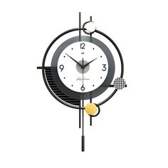 a black and white clock with yellow balls on it's face is hanging from the wall