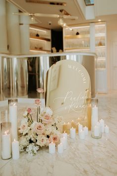 a table topped with lots of candles and flowers