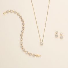 "This sparkling round halo gold wedding jewelry set will surely add brilliance to your special day! This earrings and necklace set is perfectly matched with clear AAA grade prong set cubic zirconia in a single round framed design. Perfect for the bride or makes a great bridesmaid jewelry gift!   DETAILS * High quality cubic zirconia.  * Earrings measure 1/2 inches. (pierced or clip-ons) * Necklace is adjustable from 16 inches to 18 inches long, pendant measures 8mm. * Perfect for brides, bridesm Bridesmaids Makeup, Bridesmaid Jewelry Gift, Jewelry Set Gold, Bracelet Extender, Earrings And Necklace Set, Logo Jewelry, Gold Bracelet Set, Wedding Jewelry Set, Crystal Jewelry Sets