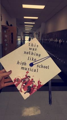 someone holding up a graduation cap that says, this is nothing like high school musical