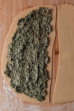 a pizza crust is covered with herbs and ready to go into the oven